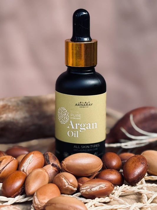 Aknaray Pure Moroccan Argan Oil 30ml bottle surrounded by argan nuts – organic cold-pressed skincare